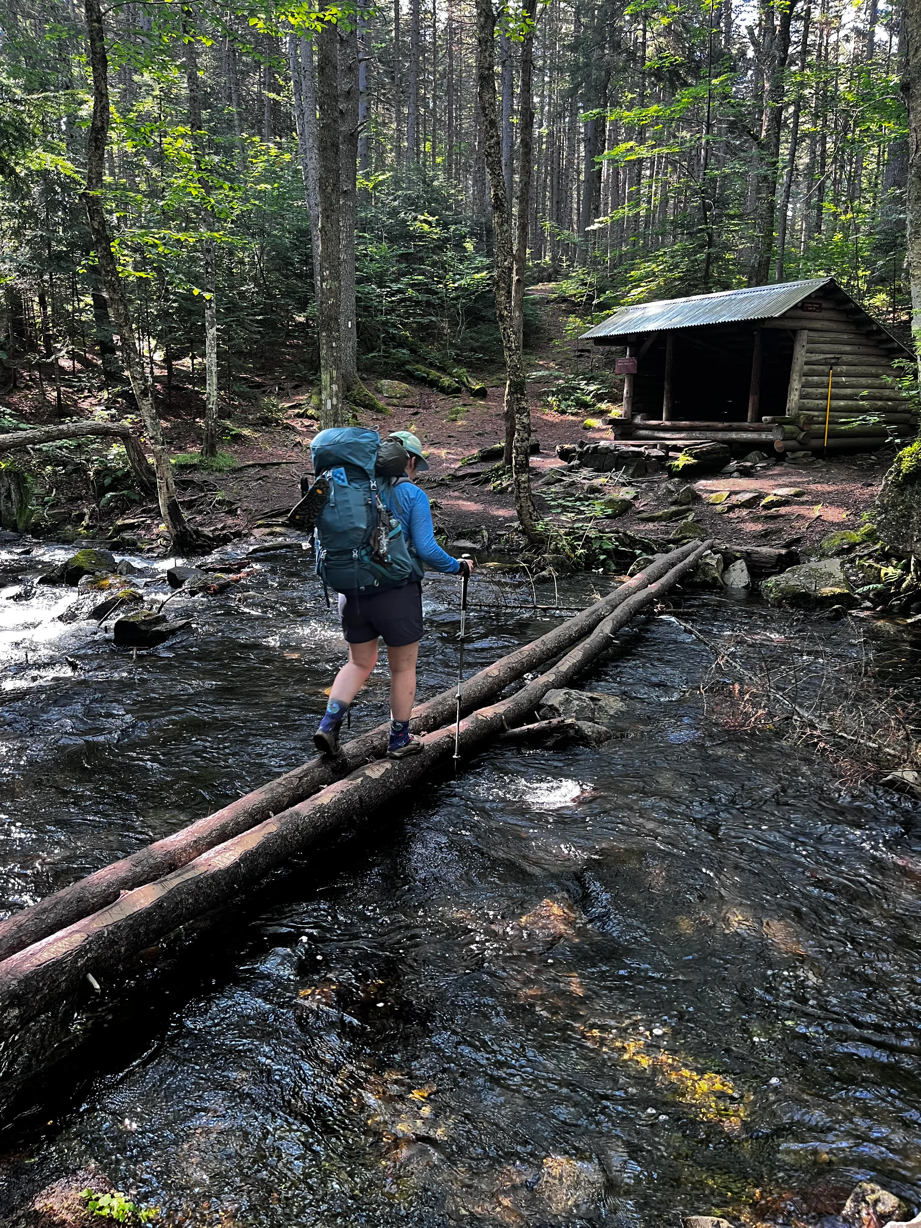 Fording one of the many rivers in the 100 Mile Wilderness Hiker crossing a river in the 100 Mile Wilderness